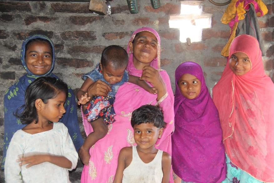 Rabiya with her family after she was classified as a well-nourished child.